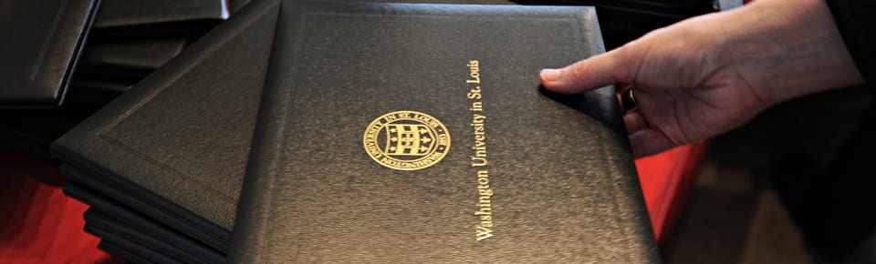 A black diploma cover with gold lettering.